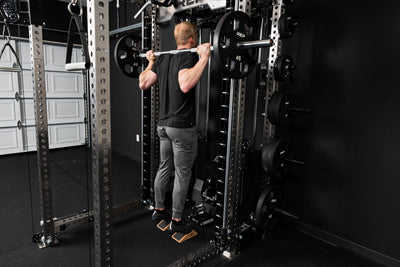 Athlete doing calf raises on the Smith Machine inside a power rack